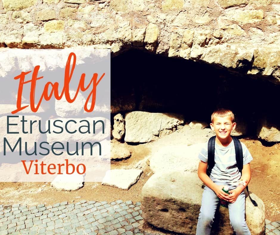 Image of boy sitting near Etruscan wall ruins in Viterbo with text overlay - Etruscan Museum, Viterbo Italy