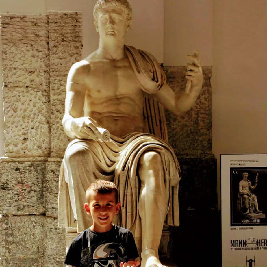 image of boy with Roman sculpture at the Naples Archaeology Museum. www.captivatingcompass.com