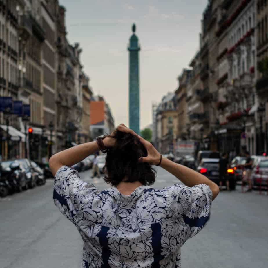 image of woman pulling hair whilst standing in middle of European street looking lost at www.captivatingcompass.com