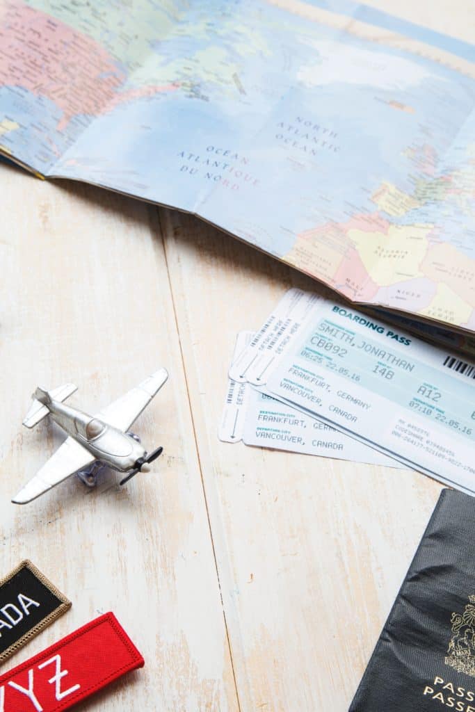 image of map, plane tickets and tiny toy plane