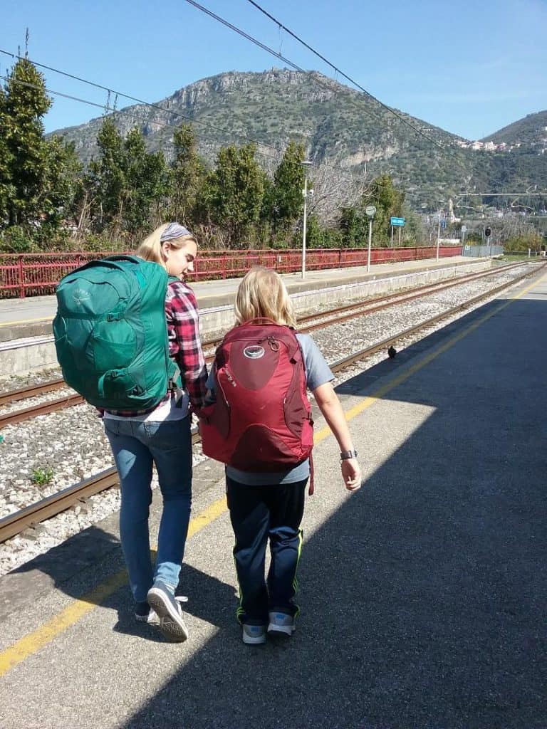 image of girls with backpacks at train station from World Wise Kids.