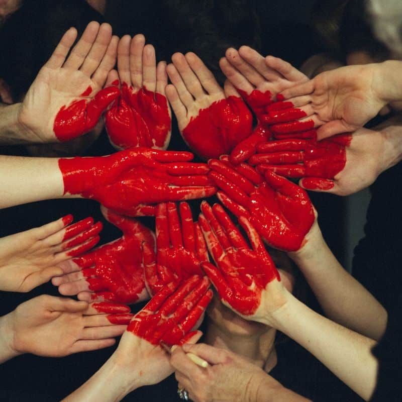 red heart painted on hands