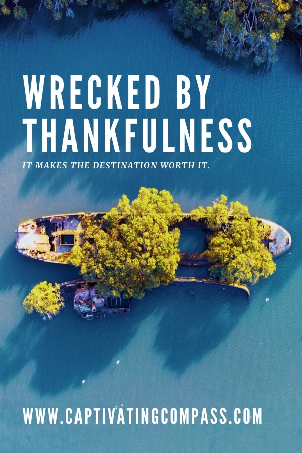 image of wrecked boat with trees growing out of it in a clear blue ocean with text overlay. Wrecked by Thankfulneess by www.CaptivatingCompass.com