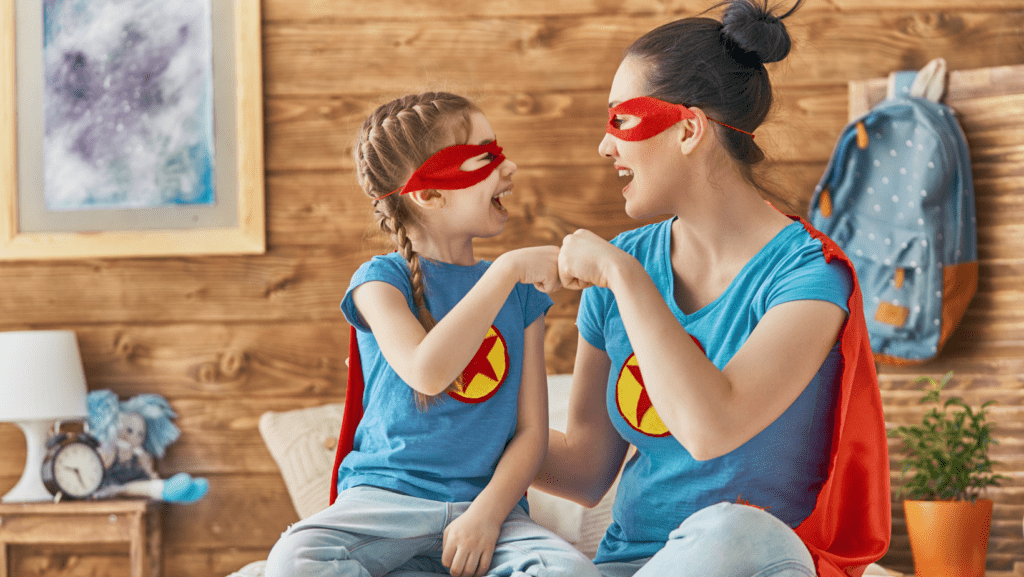 image of mom and daughter in superhero dress-up costumes having fun homeschooling  with an awesome homeschool routine from www.captivatingcompass.com